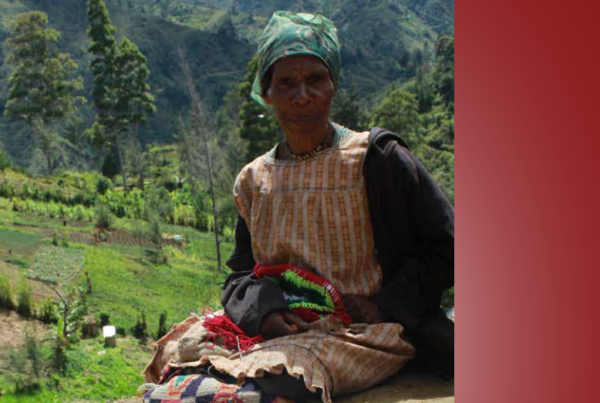 Woman sitting on ground selling product